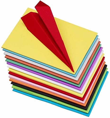 A stack of A4 sheets in multiple colours with a paper rocket on top.