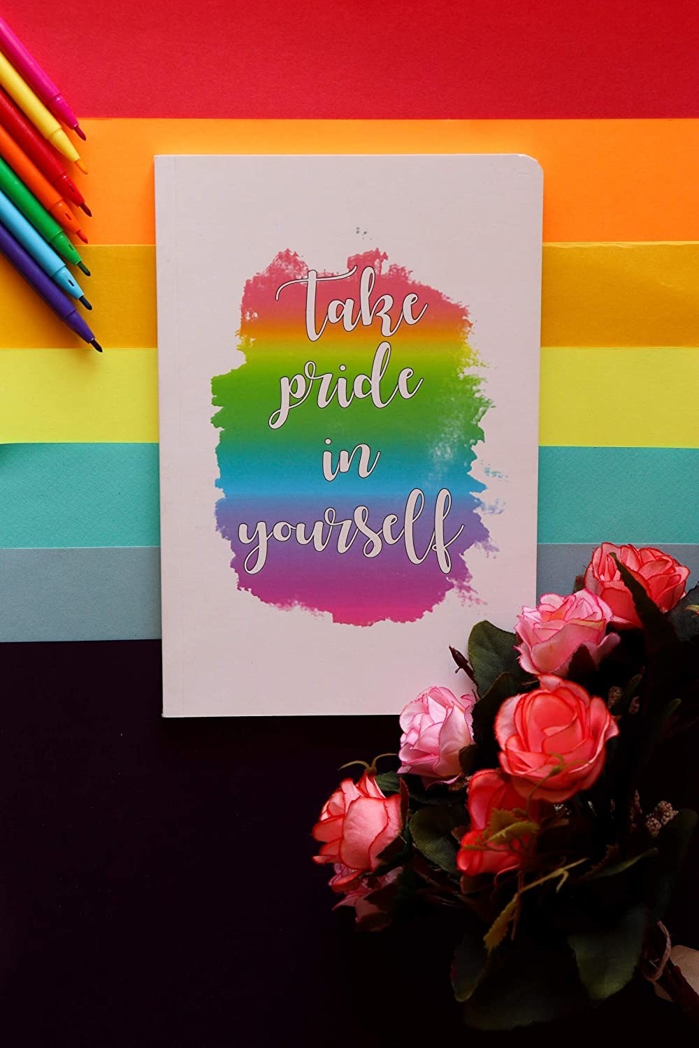 Rainbow-coloured notebook that says &#x27;Take Pride in Yourself&#x27;