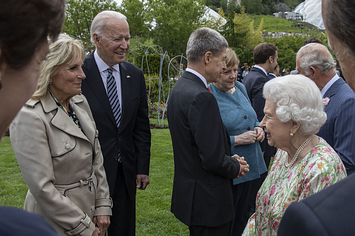 The queen is shown chatting with the Bidens