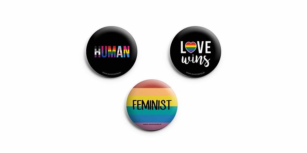 Button Badges that say Human, Love Wins, and Feminist.