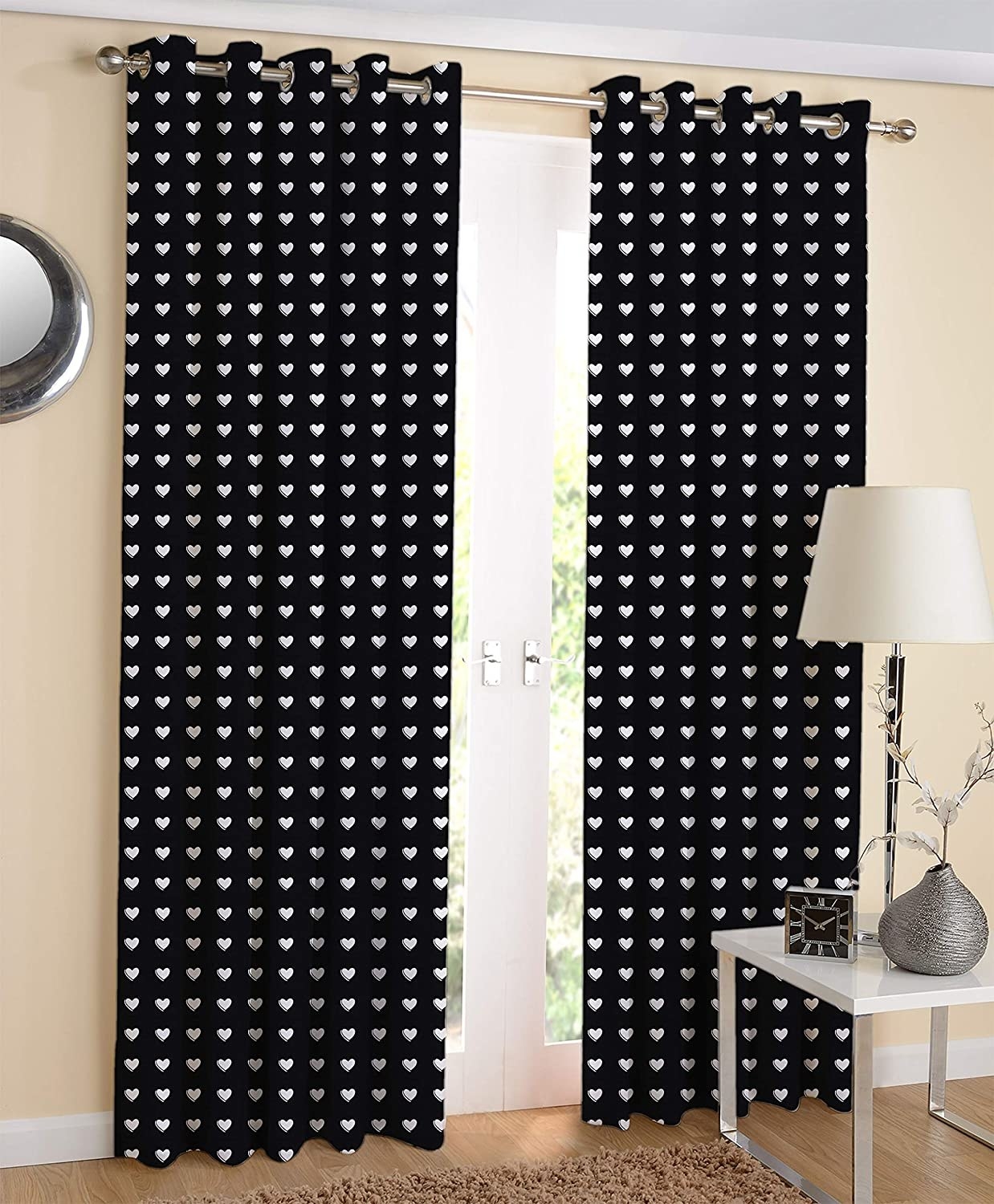 A pair of black curtains hanging in front of a door.