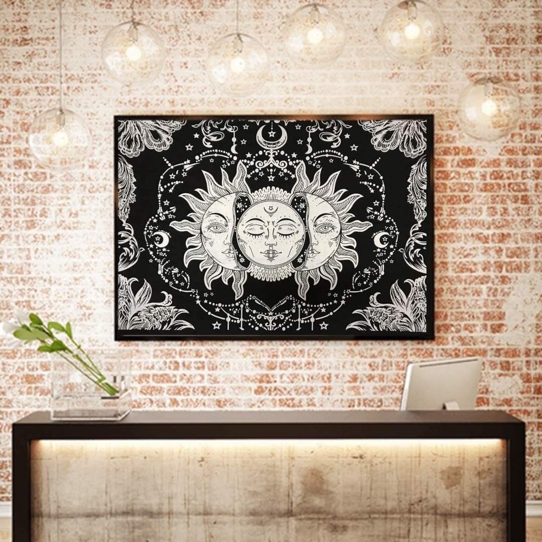 A sun tarot wall tapestry hanging on a wall. 
