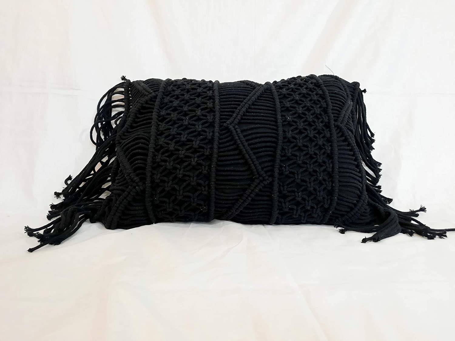 A black macrame cushion cover.