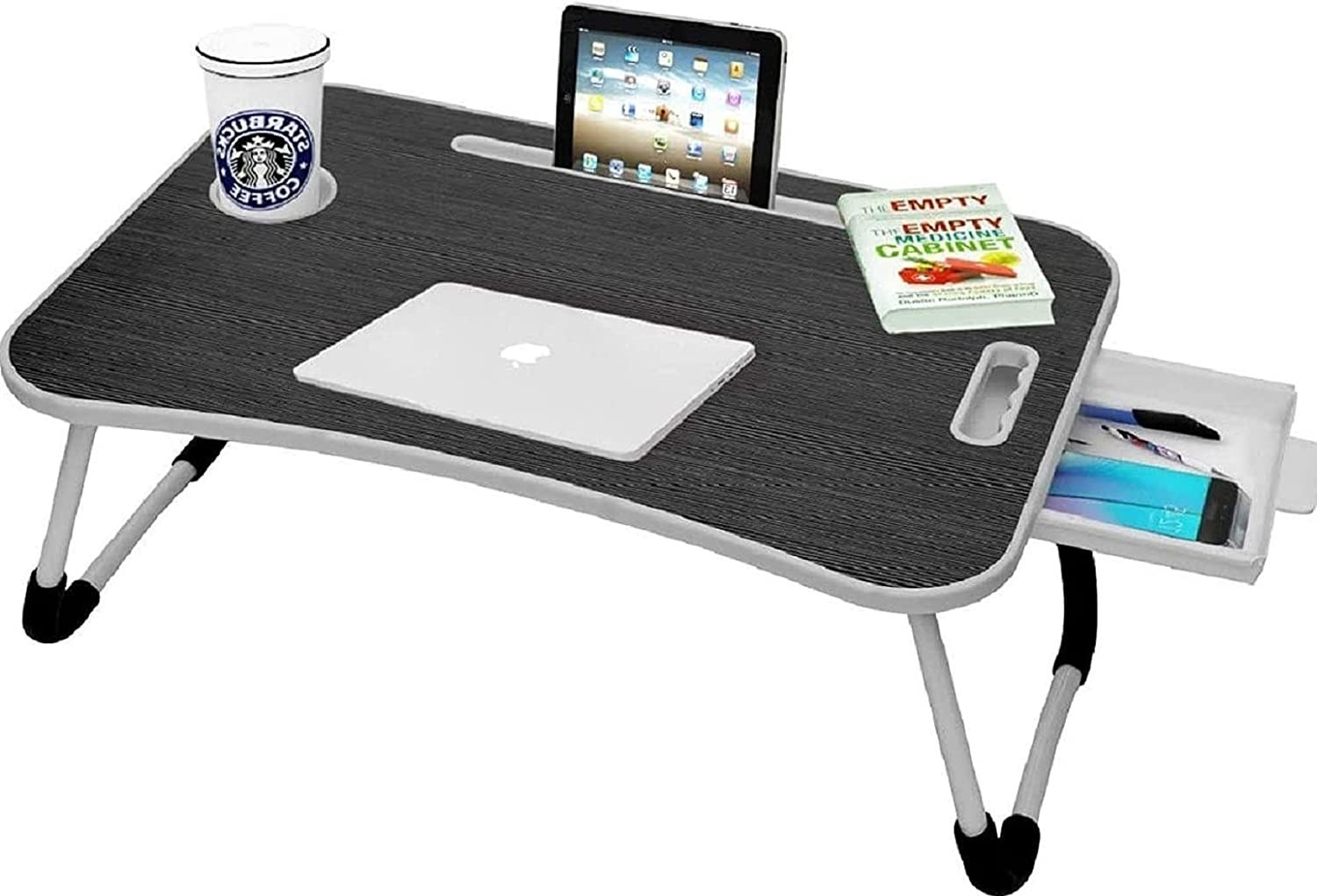 A Callas Laptop Table in black holding a cup, a book, and various computing devices. 