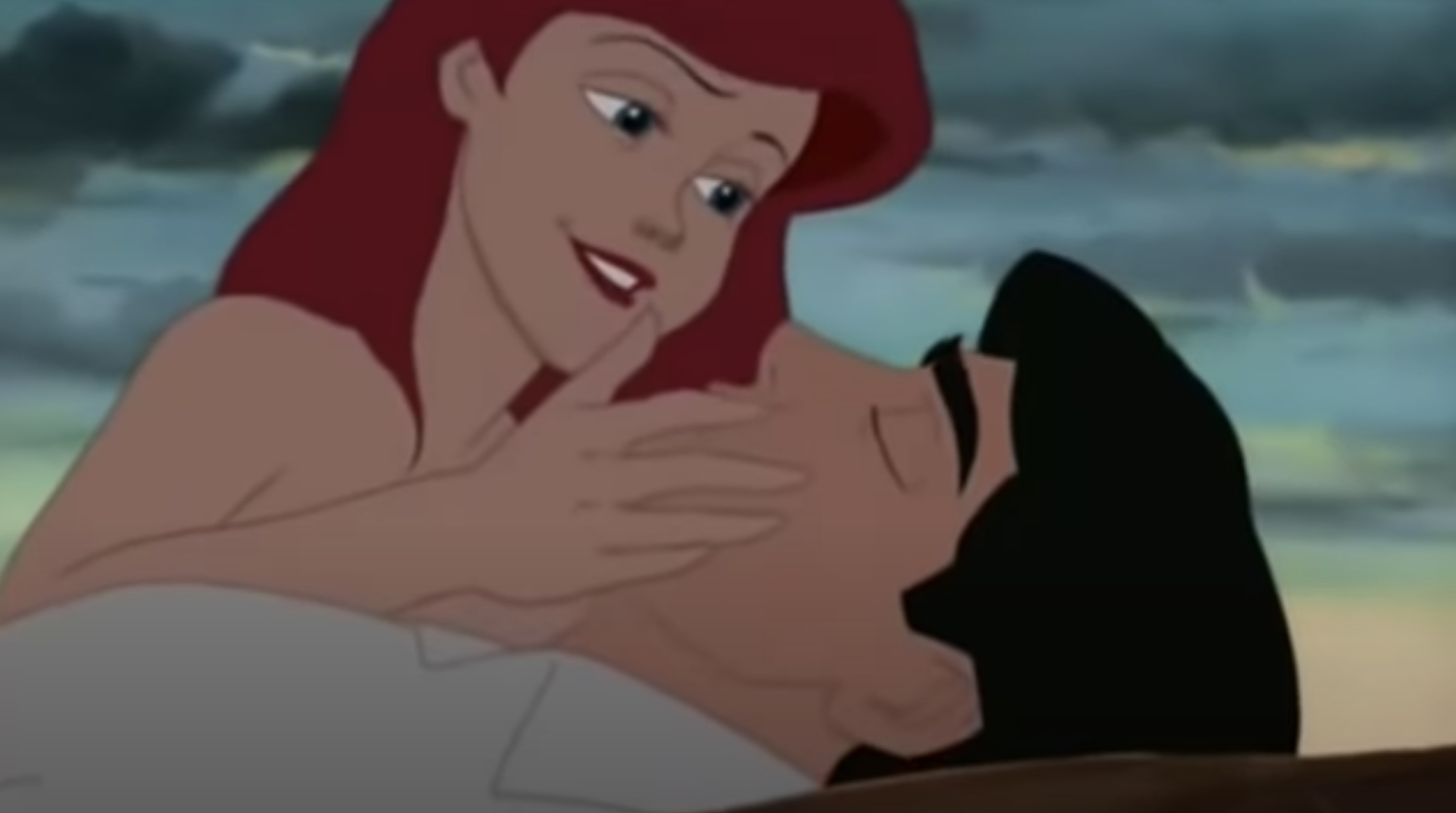 Animated shot of Ariel cupping the face of a prone Eric in her hands