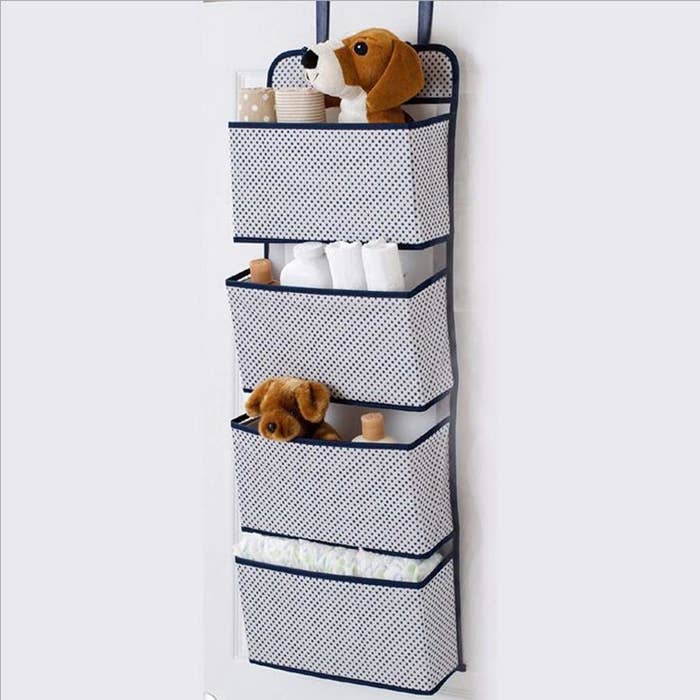 An over-the-door organiser with toys and toiletries in it 