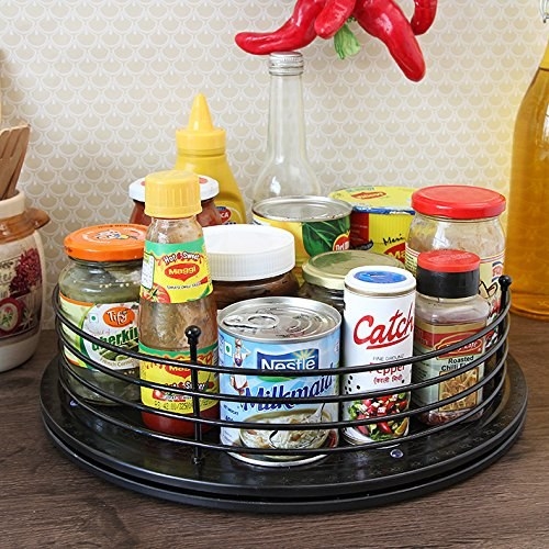 A rotating organiser with spices and condiments on it 