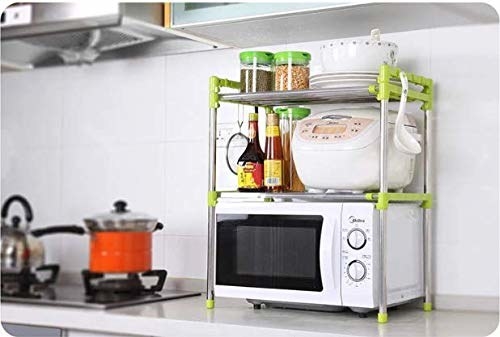 An oven with an organiser above it containing plates and condiments 