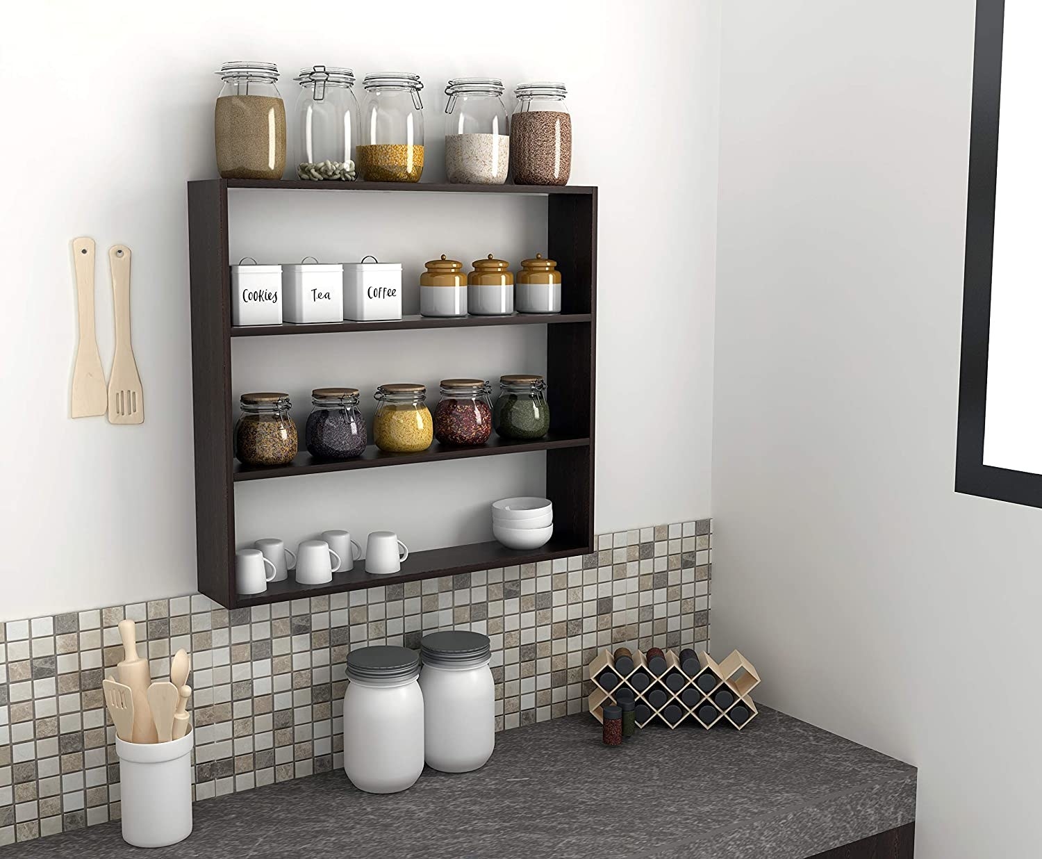 A wall rack with spice jars and cups and plates 