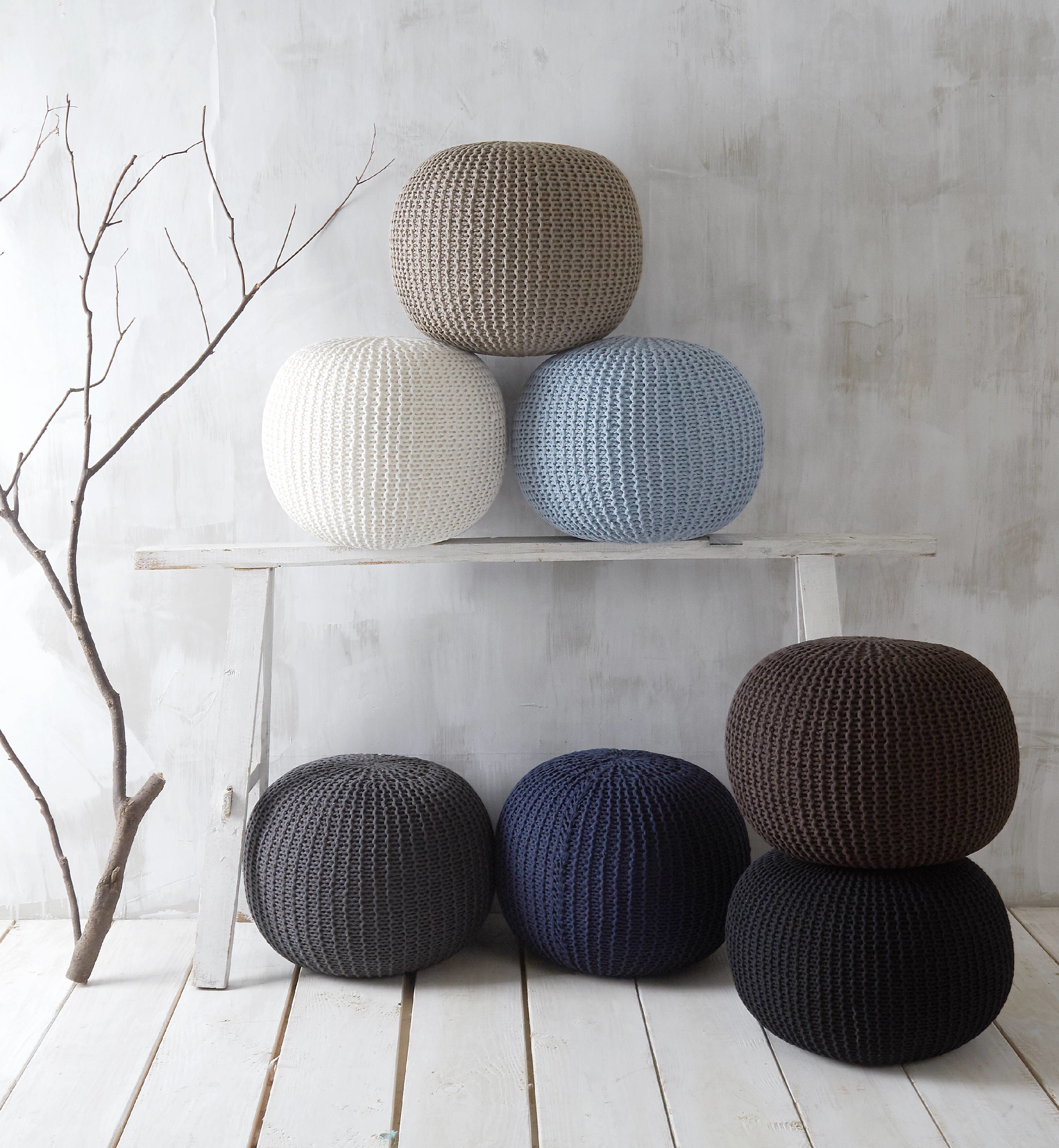 woven round pouf in hues of blue, brown, black, and white