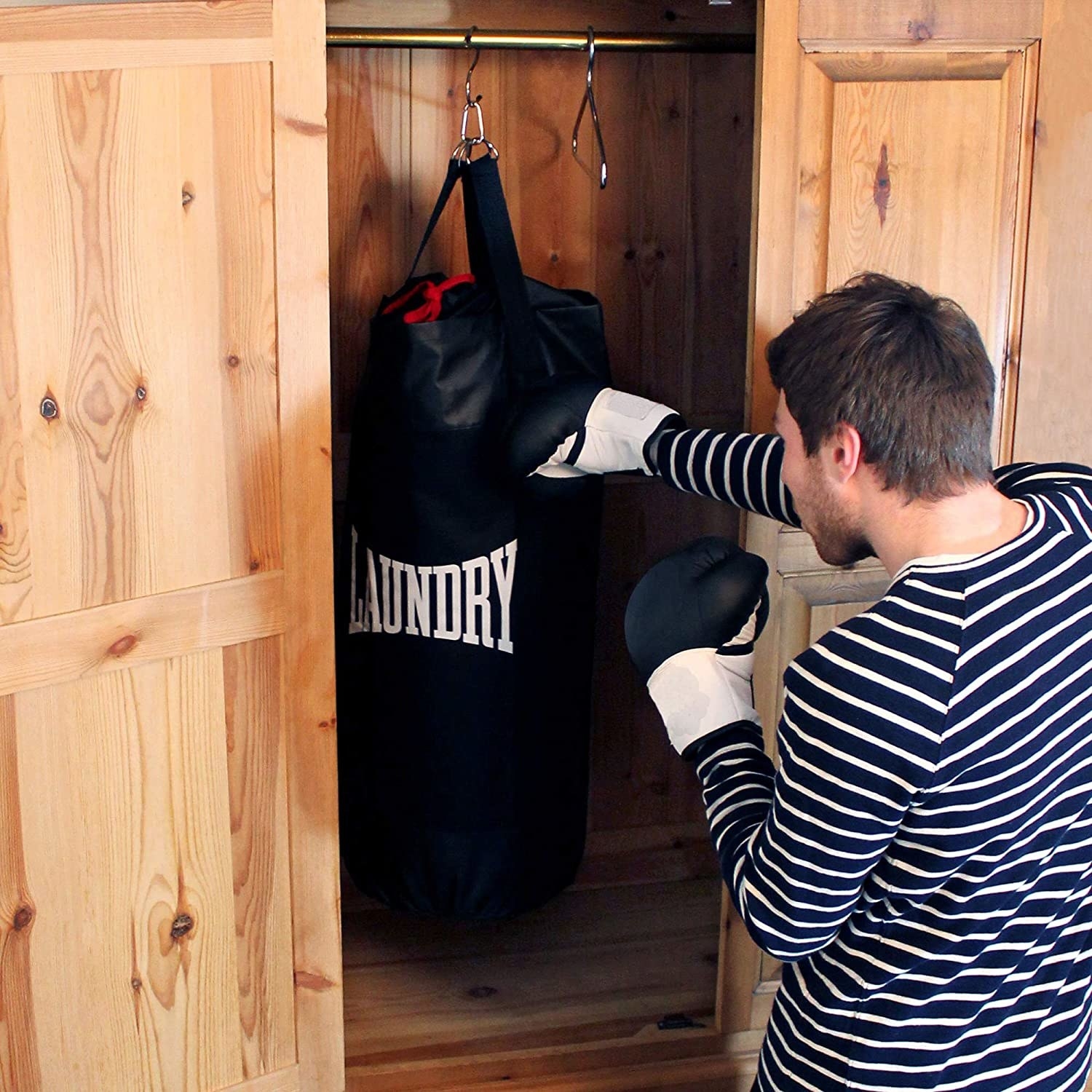 A person punching the filled bag