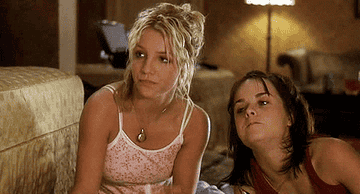 Britney Spears and Taryn Manning enjoy snacks while sitting on the ground, on set of 2002&#x27;s &quot;Crossroads&quot;
