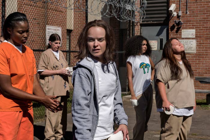 Taryn Manning stands in a prison courtyard on set of "Orange Is The New Black," Season 5