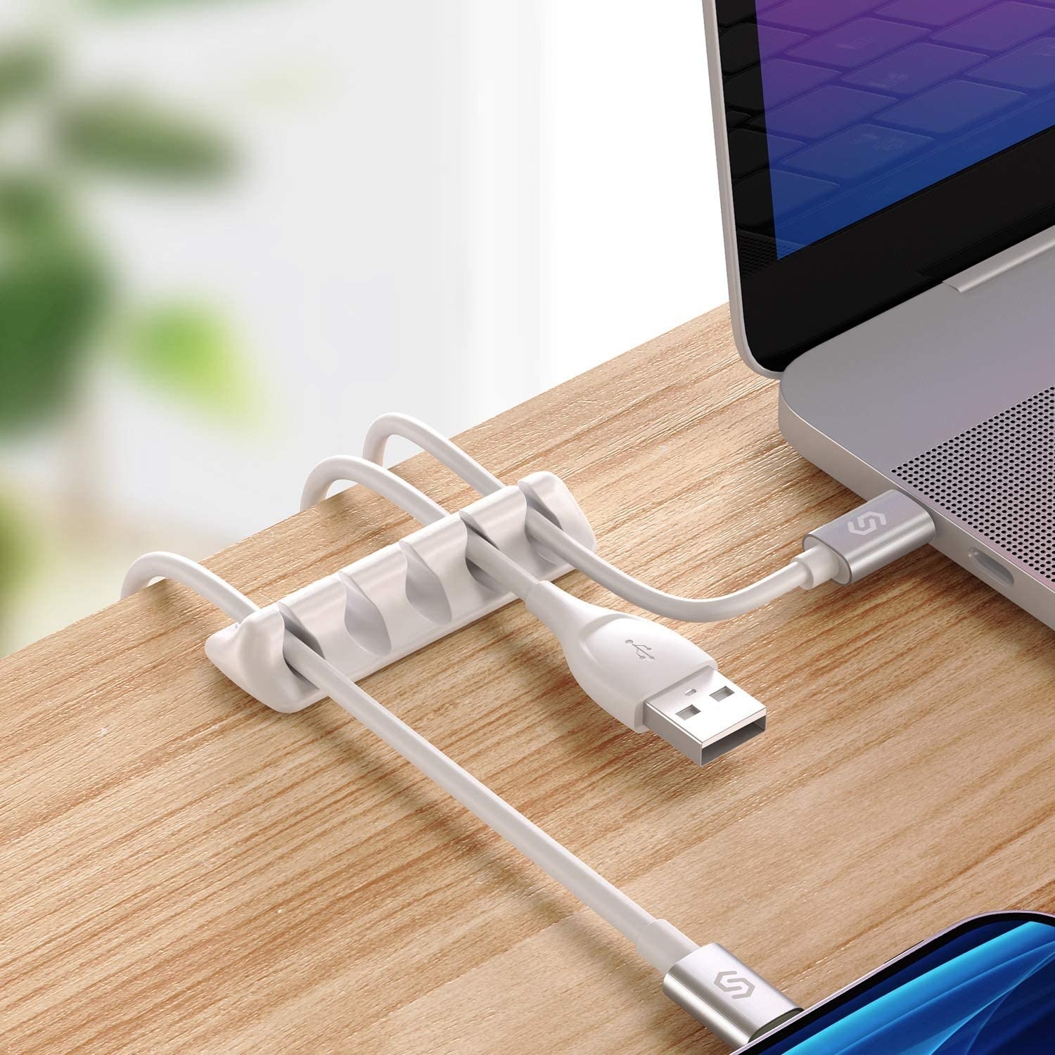 A close up of the sleek cable organizer on a desk top
