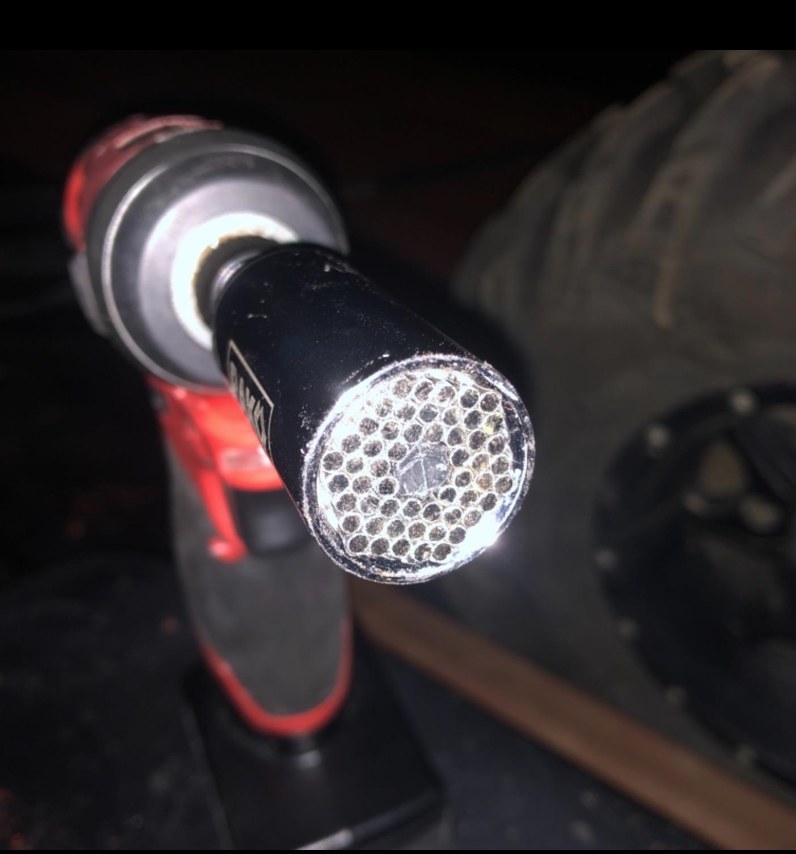 A close up of a reviewer&#x27;s silver, red and black socket grip