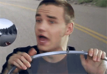 Liam Payne rides on a motorcycle and looks scared 