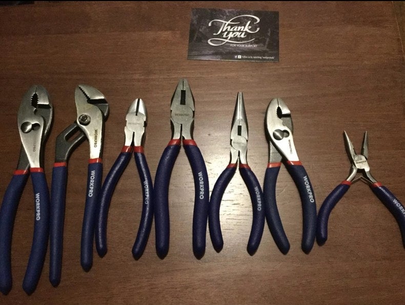 A reviewer&#x27;s set of seven pliers with blue and red handles