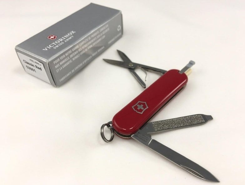 A reviewer&#x27;s red swiss army knife with nail file and knife feature out