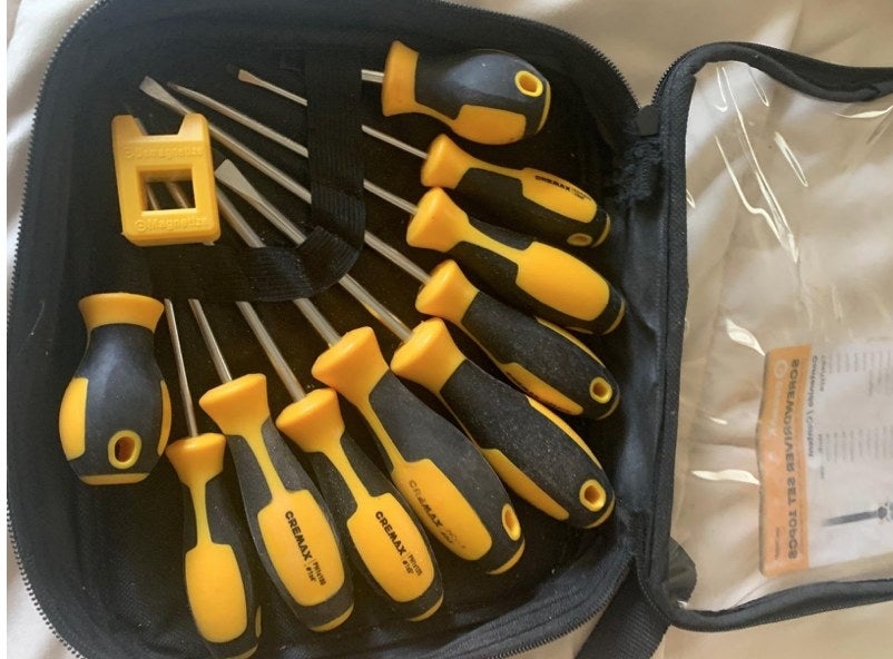 A reviewer&#x27;s carrying case with yellow and black screwdrivers in it