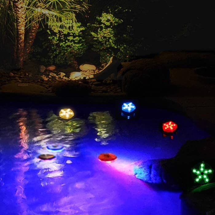a group of pool lights in some water