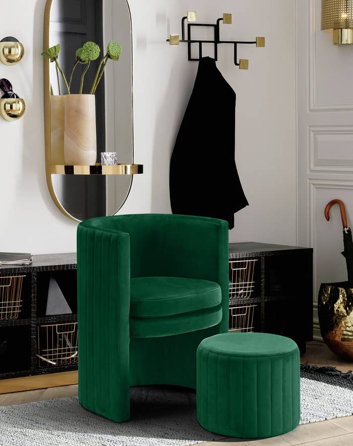 green velvet accent chair and matching ottoman staged in a stylish living room