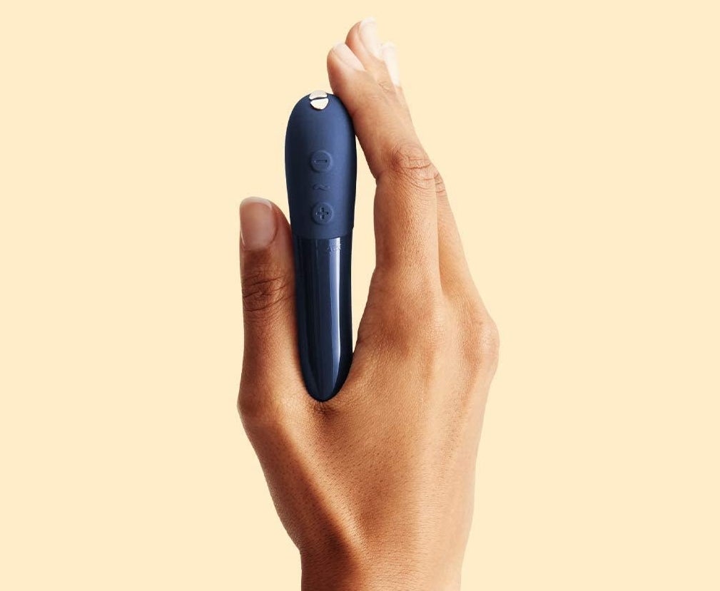 Model holding blue bullet vibrator