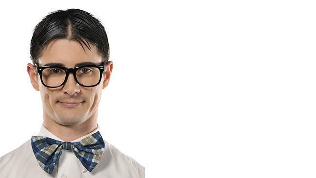 A white man with a center part, bowtie, and big glasses. 