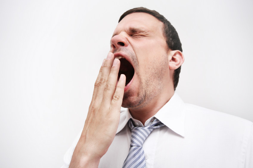 A white man yawning