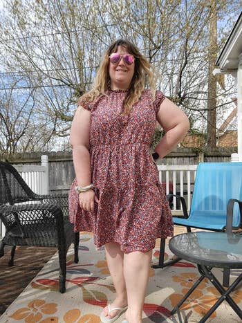 another reviewer wearing the dress in a red floral pattern