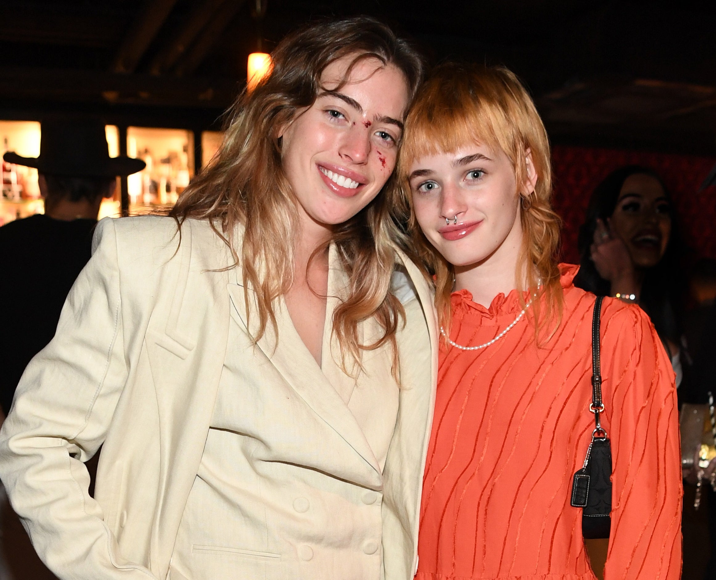 Clara smiles while posing with her sister at the event