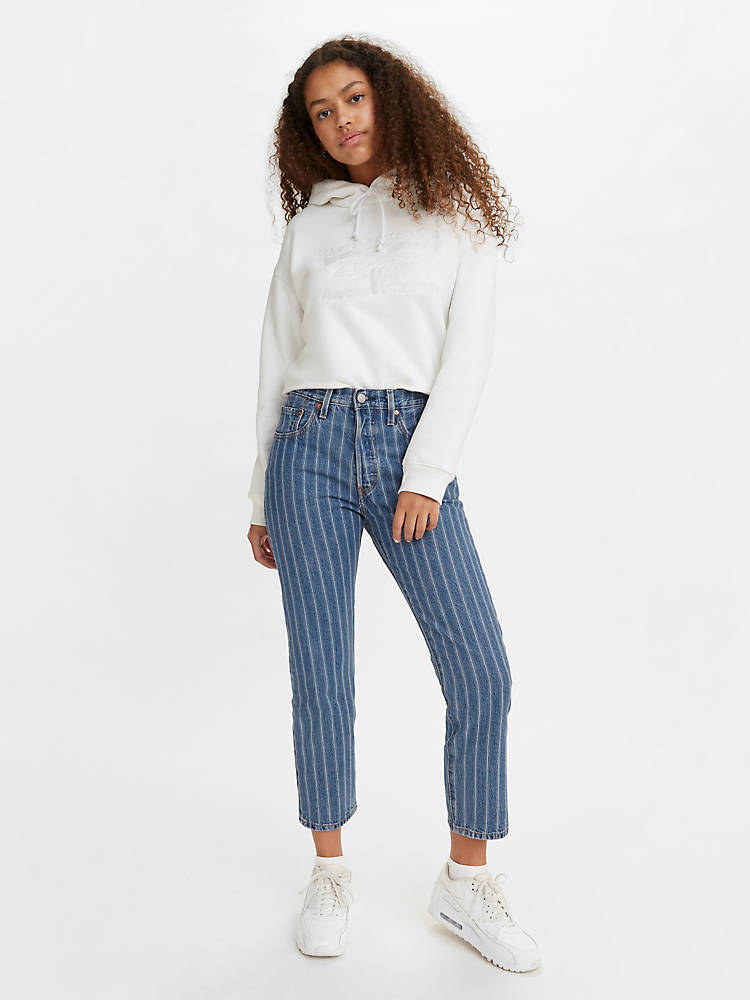 model in high-rise crop dark jeans with wide light vertical pinstripes