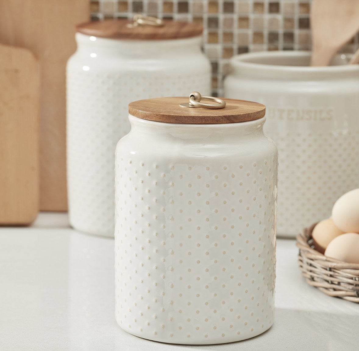 the white canister which has raised polka-dot detailing