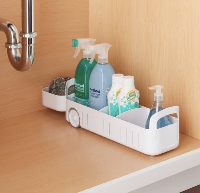 the white caddy holding cleaners and toiletries