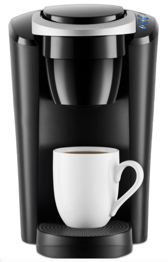 the black Keurig machine with a mug full of coffee