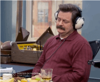 Ron Swanson listening to something on headphones