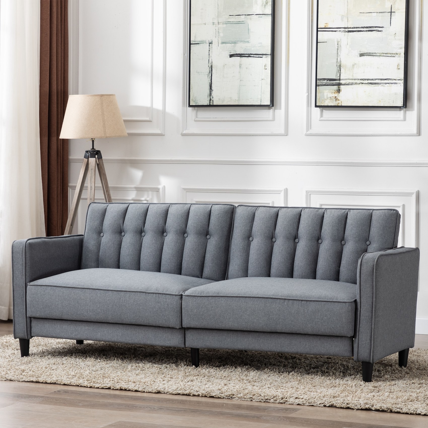 The plush blue couch with a back cushion that has button tufting and vertical lines