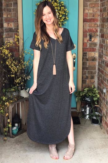 reviewer wearing the gray maxi dress and a long necklace