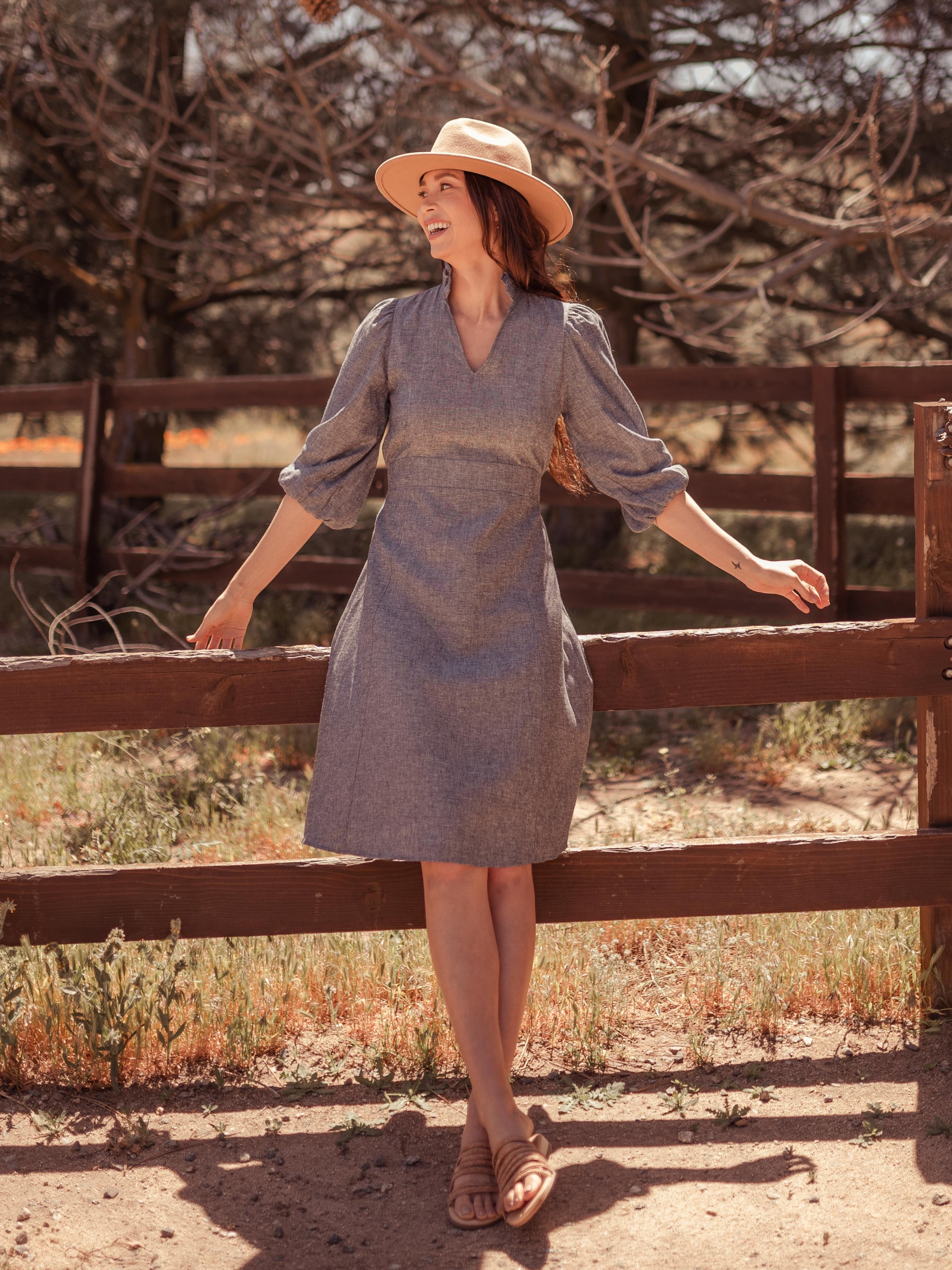 A model wearing the Sodalin Hemp Midi Dress with a hat and sandals