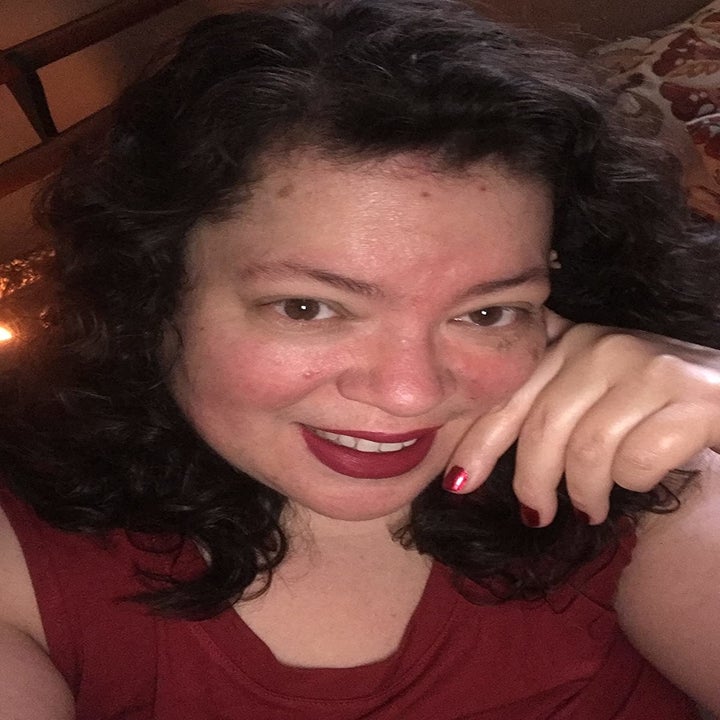 reviewer wearing berry shade