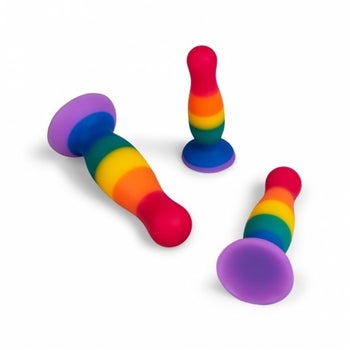 Three rainbow stripe silicone butt plugs shown from different angles
