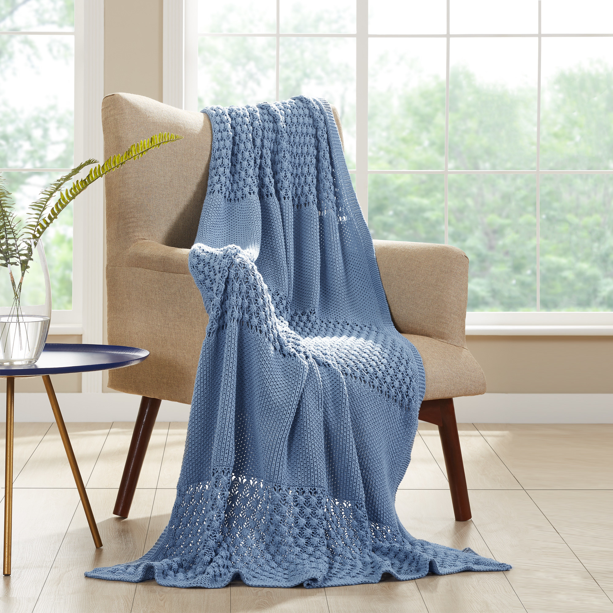 a blue throw blanket over a chair