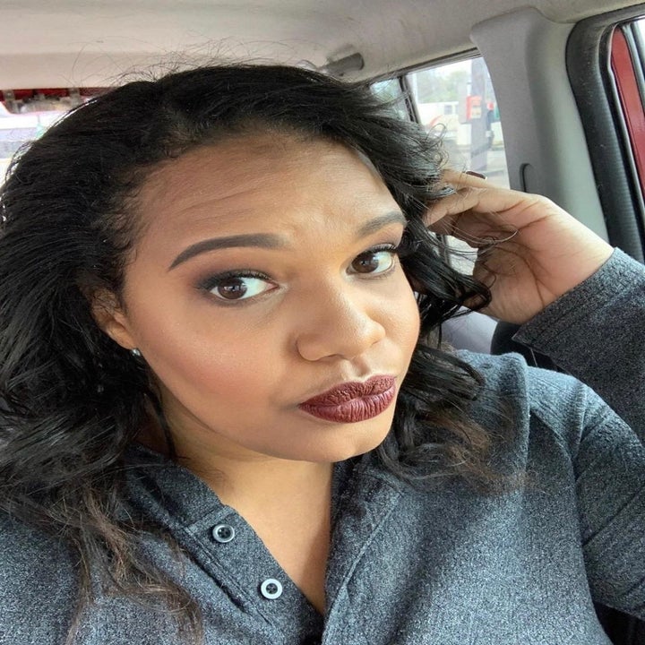 reviewer wearing dark burgundy shade