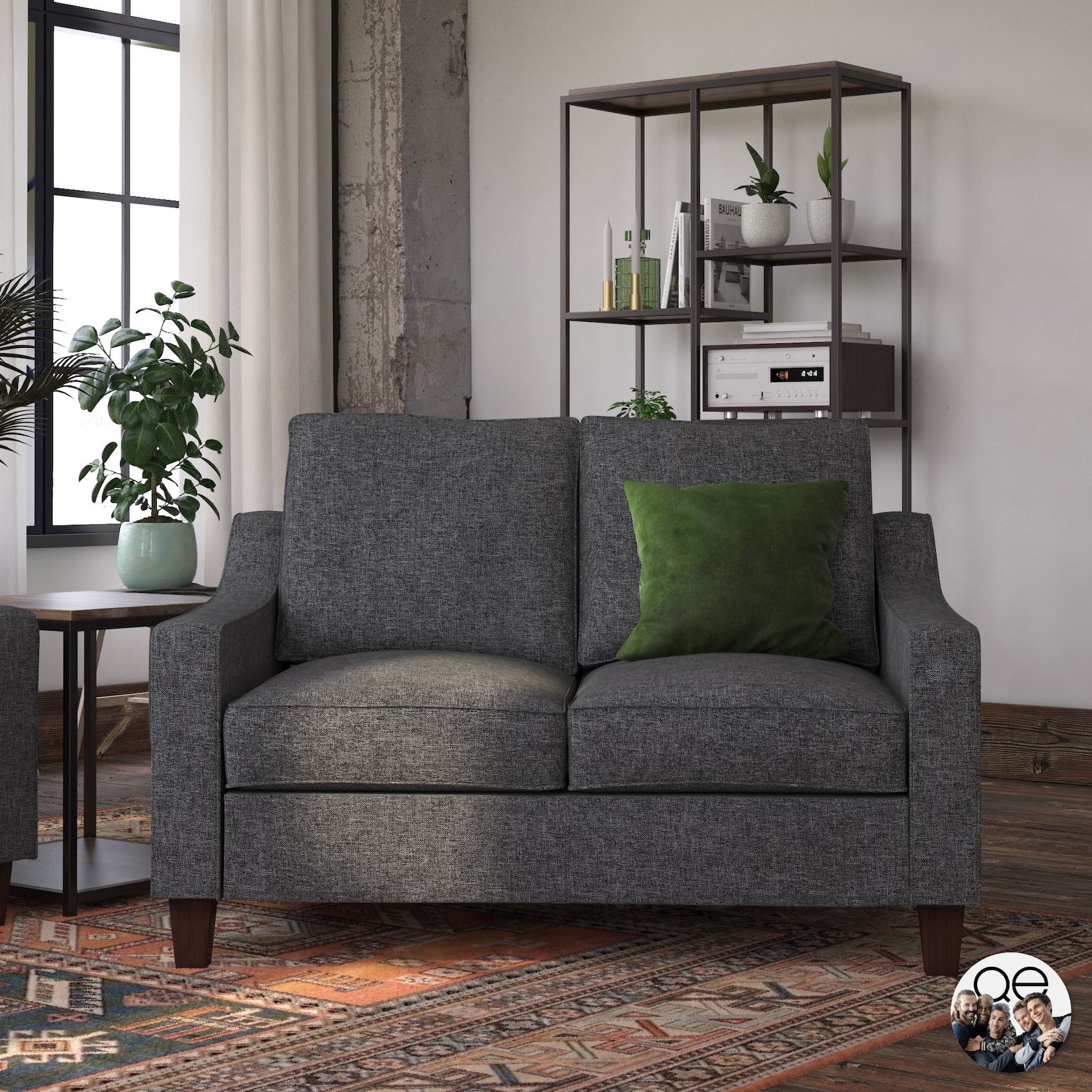 The gray two-seater couch with sleigh arms and wooden legs