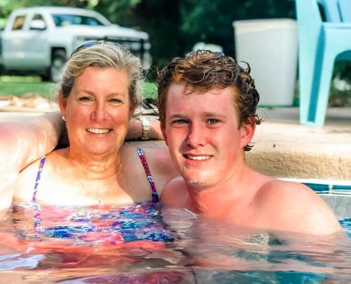 A woman and man smile together in a swimming pool