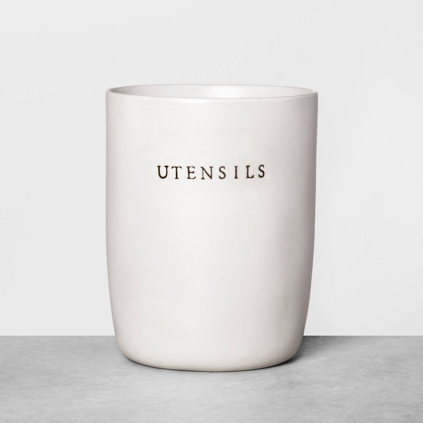 white stomeware utensil holder with &quot;utensils&quot; on the front