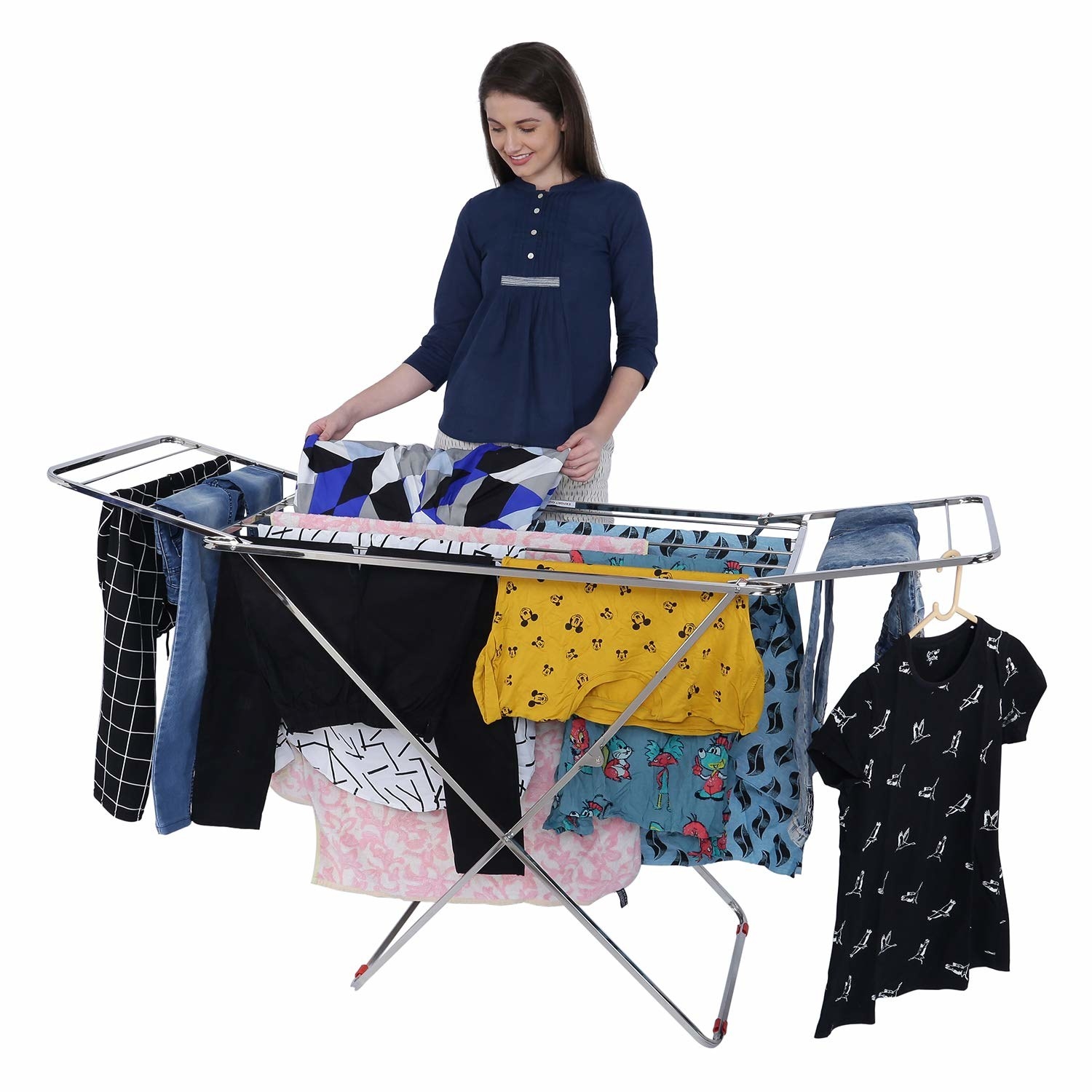 A woman hanging clothes on the clothes rack 