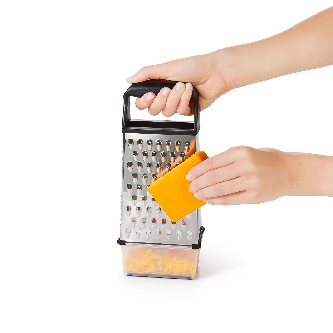 model holding a block of cheese against a box grater