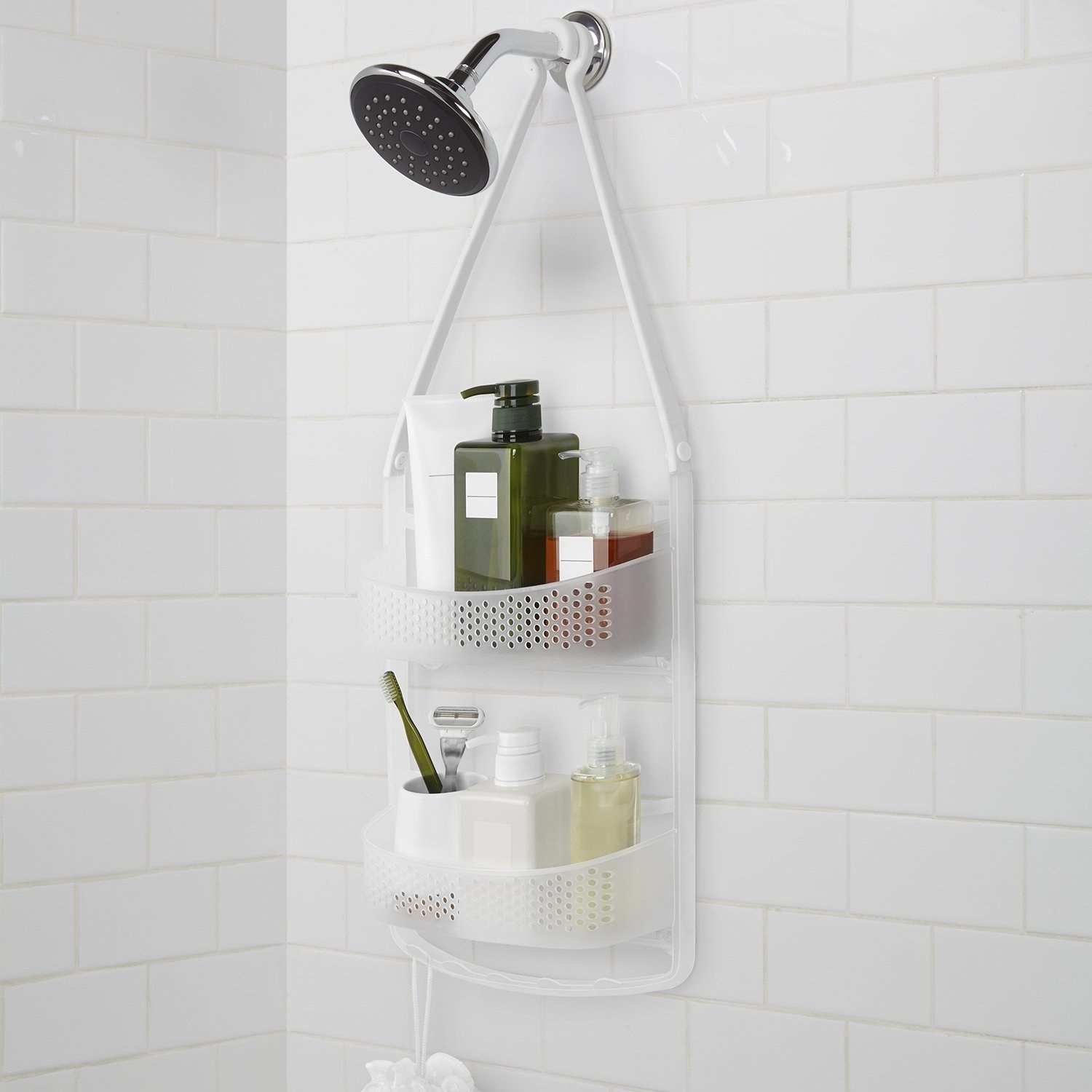 A caddy hung on a showerhead with toiletries in it