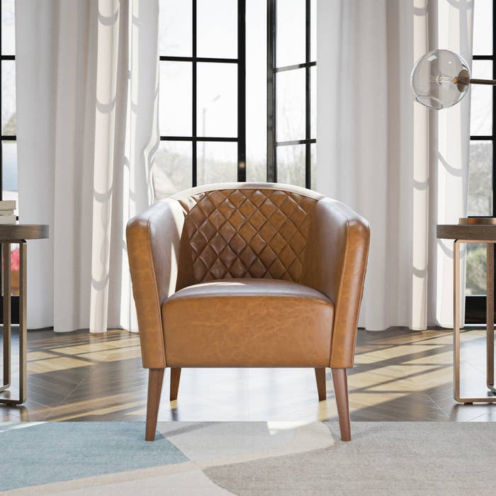 brown faux leather barrel chair with diamond tufted detail