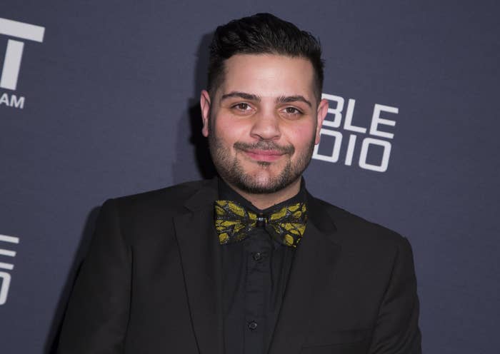 Michael Costello wears a black suit and a black-and-yellow bow tie at a charity event